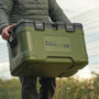  RidgeMonkey CoolaBox Compact being carried by a man from the handles 