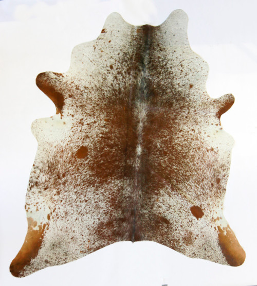Brown and white cowhide rug with warm tones and natural markings