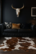 Classic  sofa  with  Brown &  white  cowhide  of  floor  in  front  of  it