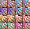 Dumb Luck Nail Polish, a collection of colorful nail polish bottles with matching painted nails in various shades including silver, blue, purple, turquoise, yellow, peach, green, and pink.