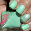 Dumb Luck Nail Polish, mint green nail polish with iridescent shimmer on manicured fingernails.