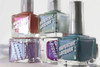 Shrinking Violet Nail Polish, collection of five colorful nail polish bottles with silver caps, showcasing pastel blue, purple, coral, and teal shades.