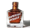Crown Of Thorns Nail Polish, a glass bottle with shimmering gold and red glitter nail polish labeled 'SuperChic Lacquer'.