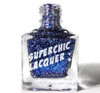 In The Twinkling Of An Eye Nail Polish, a glass bottle of glittery blue nail polish with the label 'Superchic Lacquer' featuring sparkling glitter particles inside.