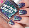On A Wing And A Prayer Nail Polish, glittery holographic purple and green nail polish on fingernails with close-up view.