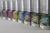 Skin Tight Nail Polish, a line of colorful glitter nail polish bottles with silver caps arranged in a row.