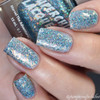 Crazy On You Nail Polish, close-up of fingernails with multi-colored holographic glitter nail polish in blue, silver, and gold shades.