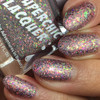 Love Is A Battlefield Nail Polish, close-up of nails painted with sparkly multicolored glitter nail polish.