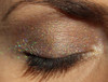 Tickles & Giggles Holographic Eyeshadow, close-up of a woman's eye showcasing shimmering holographic eyeshadow with multicolored glitter effects on the eyelid.
