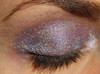 Uncatchable Holographic Eyeshadow, close-up view of eye with shimmering, multicolored holographic eyeshadow applied on eyelid.