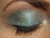 Tagalong Holographic Eyeshadow, close-up of an eyelid adorned with shimmering holographic eyeshadow with multicolored sparkles.