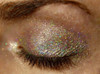Trick Pony Holographic Eyeshadow, close-up of shimmering holographic eyeshadow on closed eyelid with glittery multi-colored sparkle.