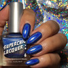 Throwing Shade Nail Polish, hand with blue holographic nail polish against a glittery multicolor background.