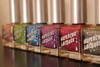 Stroke Of Midnight Holographic Nail Polish, collection of holographic nail polish bottles with colorful, sparkly finishes and silver caps.