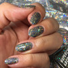Stroke Of Midnight Holographic Nail Polish, close-up of nails painted with shimmery holographic black nail polish with multicolored glitter flakes.