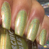Infectious Nail Polish, holographic shimmering gold-green nail polish on fingernails.