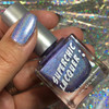 Viral Nail Polish, holographic blue nail polish on fingernail with glittery background.