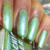 Germaphobe Nail Polish, close-up of holographic green nail polish on fingernails with a shiny, iridescent finish.