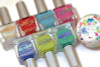 Rock Hard Nail Polish, colorful nail polish bottles in various shades with metallic caps.