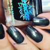 SuperChic Morticia Addams Nail Polish, black nail polish with holographic glitter finish on well-manicured nails.