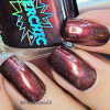 SuperChic Vampira Nail Polish, close-up of fingernails painted with a deep red and black galaxy-effect nail polish with fine holographic glitter, showcasing a bold and eye-catching manicure.