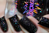 My Silly Shadow Nail Polish, close-up view of black glittery nails with holographic sparkles and a bottle of shadow nail polish with holographic lettering.