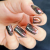 My Silly Shadow Nail Polish, metallic black and red glitter nail polish on fingernails.