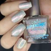 Happy Thoughts Nail Polish, holographic silver and pink iridescent nail polish with a sparkly, shiny finish on manicured nails.