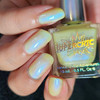 Cracking Up Nail Polish, holographic and iridescent pastel yellow nail polish on fingernails near the bottle.