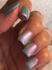 Unreal Nail Polish, hand with holographic mint green and pink iridescent nails