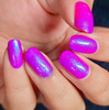 Lost In Illusions Nail Polish, vibrant holographic purple nail polish on neatly manicured nails.
