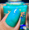 World Warp Nail Polish, close-up of a finger showcasing vibrant, shimmery turquoise nail polish with a holographic effect.