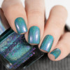 Endora Nail Polish, hand with holographic emerald green nail polish on fingernails.