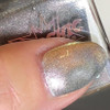 Rose Gold Tabby Holographic Multichrome Magnetic Cat Eye Topper Nail Polish, close-up of a fingernail with holographic multichrome nail polish showcasing a shimmering, cat eye effect.