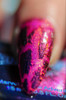 Enchanted Key NutCrackle Nail Polish - Multichrome Crackle Effects, close-up of a fingernail painted with vibrant pink, black, and multicolored crackle nail polish showcasing iridescent and crackle textures.
