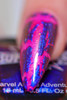 Enchanted Key NutCrackle Nail Polish - Multichrome Crackle Effects, close-up of a vibrant pink nail with multichrome crackle design in blue and purple shades.
