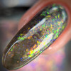 Pumpkin Patch Near Me Halloween Nail Polish, close-up of holographic nail polish with multicolored glitter on a fingertip.