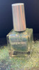 Blarney Stone Irish Nails, Green Blue Crystal Holographic Nail Polish, showcasing a clear holographic nail polish bottle with a metallic cap, surrounded by glitter reflecting holographic colors.