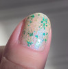Blarney Stone Irish Nails, Green Blue Crystal Holographic Nail Polish on fingernail with glitter and holographic effect.
