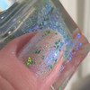 Blarney Stone Irish Nails Green Blue Crystal Holographic Nail Polish, close-up of a fingernail painted with holographic glitter nail polish featuring green and blue crystals.