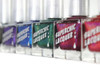 No Rest For The Wicked Nail Polish, set of colorful glitter nail lacquers in rectangular bottles with a white cap, featuring different vibrant shades with glitter and shimmer.
