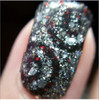 Crown Jewels Of Enchantment - Genuine Diamond Nail Polish, close-up of a fingernail painted with sparkling black and silver glitter nail polish containing tiny diamond-like particles.