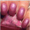 Hot Finger Nail Polish, close-up image of well-manicured fingernails painted with shimmering pinkish-purple nail polish.