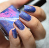 Jolt Nail Polish, vibrant blue glittery manicure with holographic sparkle.