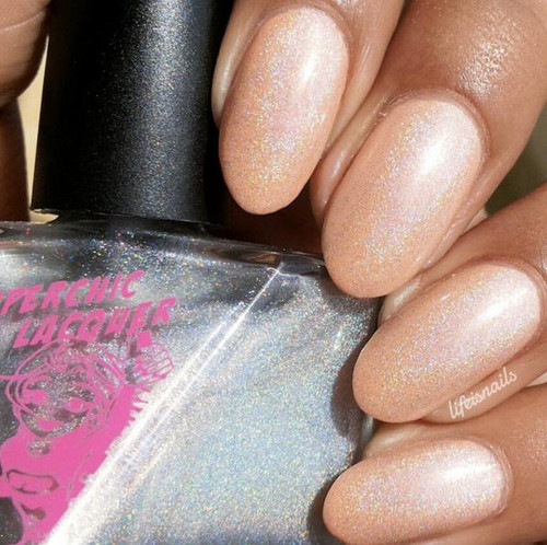 Cause & Effect Nail Polish, close-up of nails painted with a pale, iridescent glittery nail polish.