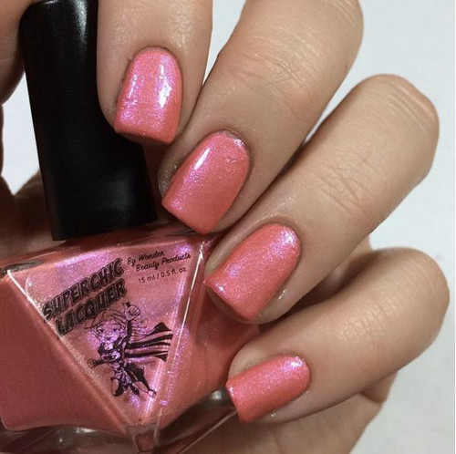 Lost My Melon Nail Polish, close-up of well-manicured nails painted with a pink, shimmer nail polish with a glossy finish.