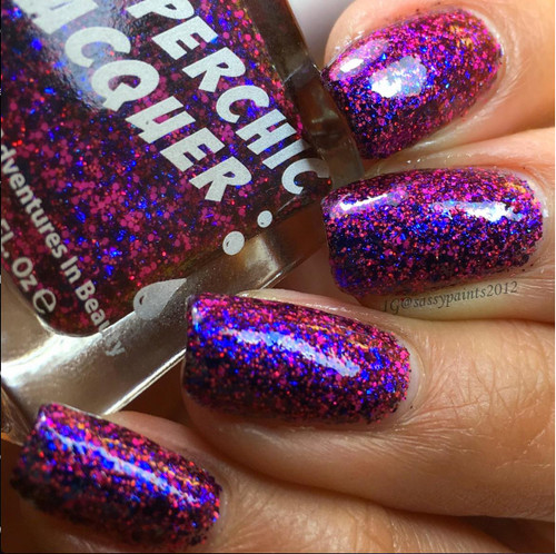 Entertaining Angels Nail Polish, close-up of nails painted with glittery pink and purple nail polish with holographic effect.
