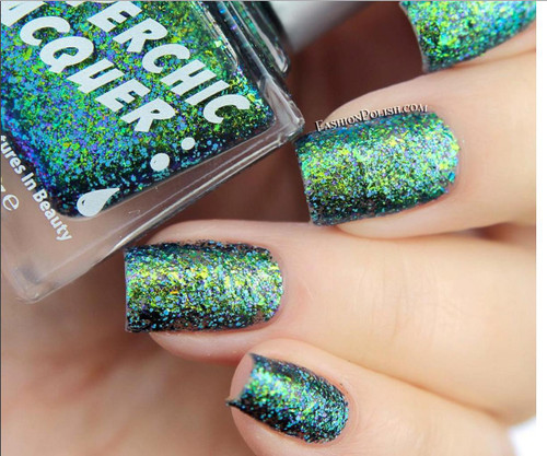 Heaven's Coordinates Nail Polish, close-up view of nails painted with holographic green and blue glitter nail polish.