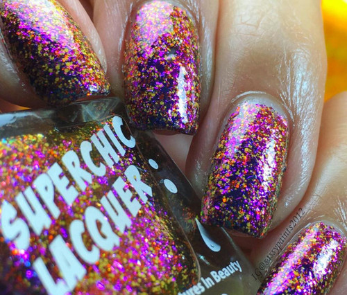 My Secret Garden Nail Polish, glittery multicolor nail polish on fingernails with a sparkly, colorful finish.