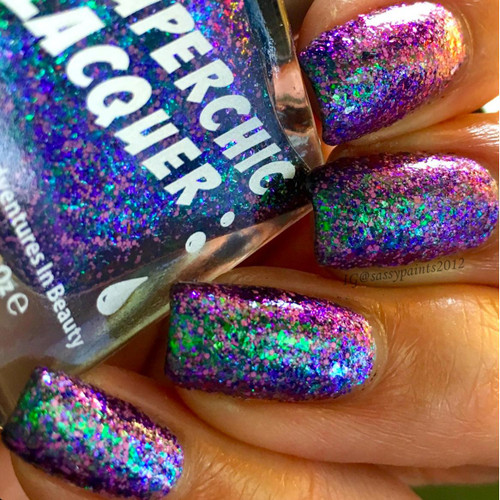 On A Wing And A Prayer Nail Polish, close-up view of vibrant multicolored holographic glitter nail polish on fingernails.